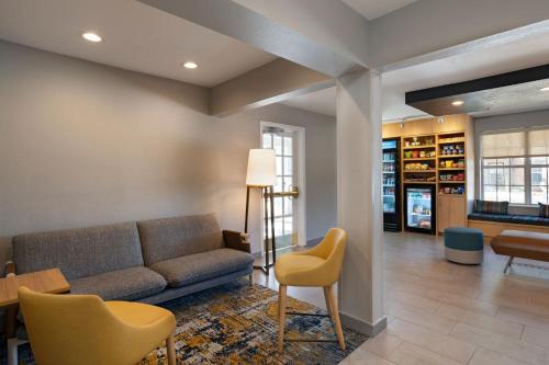 a living room with a couch and a table and chairs at TownePlace Suites by Marriott College Station in College Station
