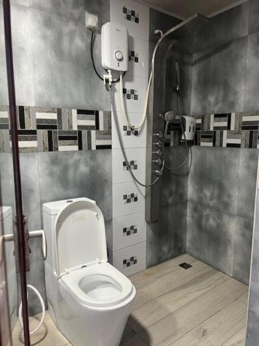 a bathroom with a toilet and a shower at Rooftop Rooms in Male City