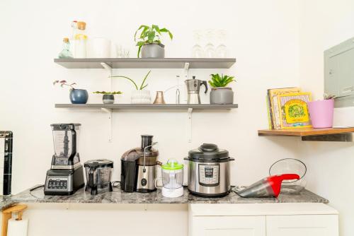 a kitchen counter with appliances on a shelf at Room in cozy house close to Lawrence Ave, WiFi, parking in Toronto