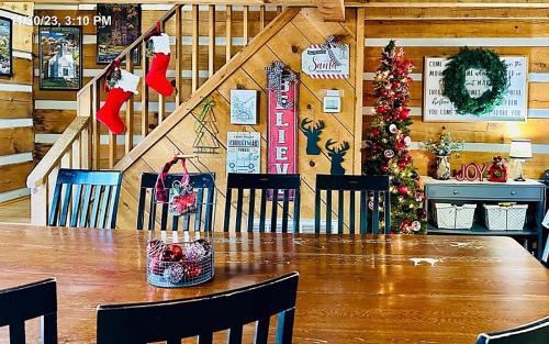 a dining room with a table and a christmas tree at Lodge at Bradley Mtn in Townsend