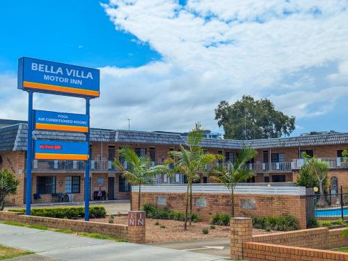 a building with a sign in front of it at Bella Villa Motor Inn in Forster