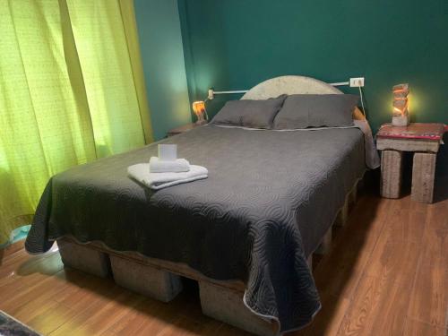 a bedroom with a bed with two towels on it at "Eucalyptus Uyuni" only dollars or euros are accepted in Uyuni