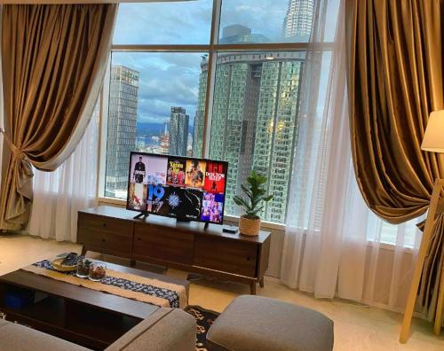 a living room with a view of a large window at Stella Maison KLCC in Kuala Lumpur