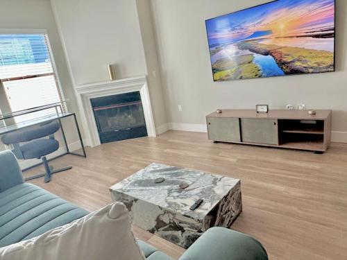 a living room with a couch and a coffee table at Cozy Large 1 Bedroom Condo by UCLA in Los Angeles