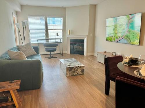 a living room with a couch and a table at Cozy Large 1 Bedroom Condo by UCLA in Los Angeles
