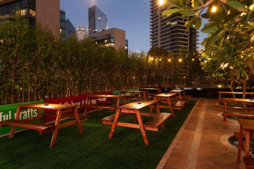 a row of picnic tables and benches in a city at Delta Hotels by Marriott Jumeirah Beach, Dubai in Dubai