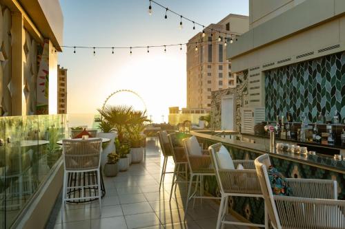 a row of chairs sitting on a rooftop patio at Delta Hotels by Marriott Jumeirah Beach, Dubai in Dubai