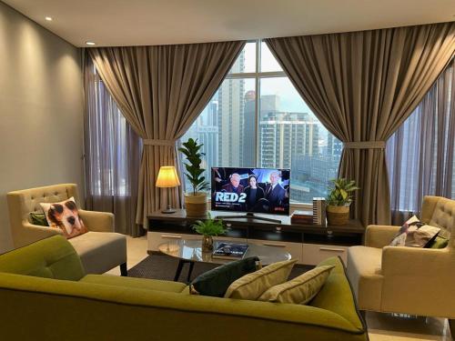 a living room with a tv and a large window at Stella Maison KLCC in Kuala Lumpur
