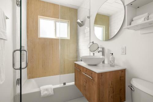 a bathroom with a sink and a mirror at NEW! Ocean View Mid-Century Modern Beach House in Manhattan Beach