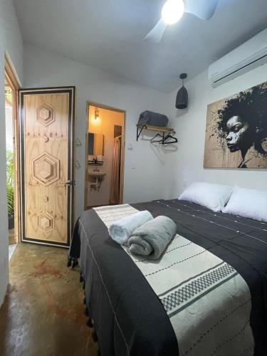 a bedroom with two beds in a room with a door at Akoma San Pancho in San Francisco