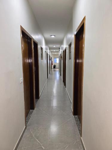 a hallway with doors and a long hallway with tile floors and a hallwayngthngth at Singular hotel in Sao Paulo