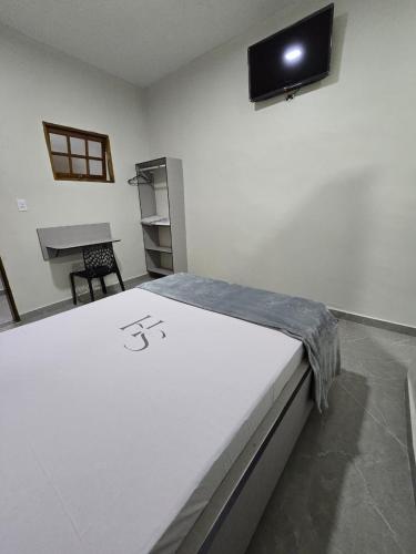 a room with a bed and a tv on the wall at Singular hotel in Sao Paulo