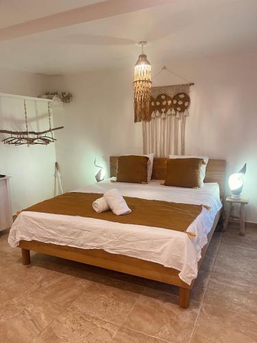 a bedroom with a large bed with two towels on it at Villa Kayooli in Trois-Rivières