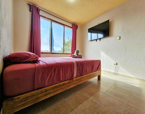 a bedroom with a bed with a laptop on it at Casa-Oxa in Ixmiquilpan