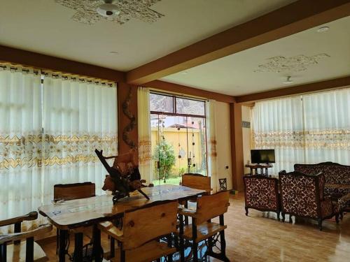 a living room with a table and chairs and a window at Casa de la chakana Chakana House Sacred Valley in Calca