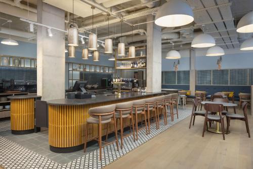 a restaurant with a bar with chairs and tables at Residence Inn by Marriott Cork in Cork