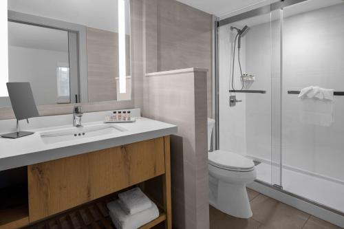 a bathroom with a toilet and a sink and a shower at Delta Hotels by Marriott Santa Clara Silicon Valley in Santa Clara