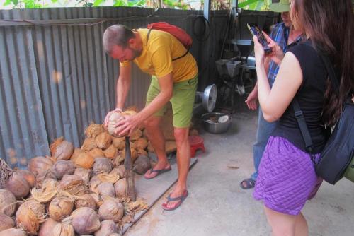 a man is standing next to a pile of onions at Ben Tre Farm Stay in Ben Tre