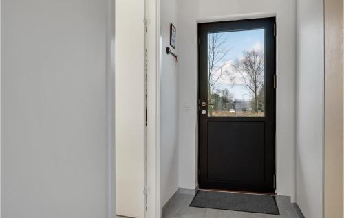a black door in a hallway with a window at 4 Bedroom Gorgeous Home In Fur in Fur