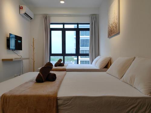 a bedroom with two beds with a teddy bear sitting on the bed at Near Airport K Avenue Family Room in Donggongon