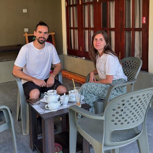 a man and a woman sitting at a table at Negombo 146 Homestay in Negombo