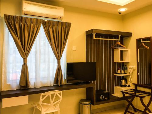 TV a/nebo společenská místnost v ubytování Louis Hotel