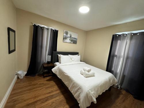 a bedroom with a bed with a teddy bear on it at Ferry Getaway Home! in Niagara Falls