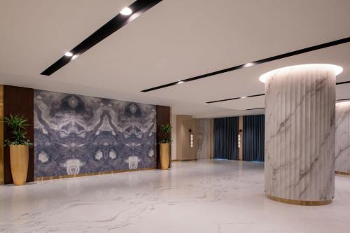 a large room with a large painting on the wall at The St. Regis Marsa Arabia Island, The Pearl Qatar in Doha