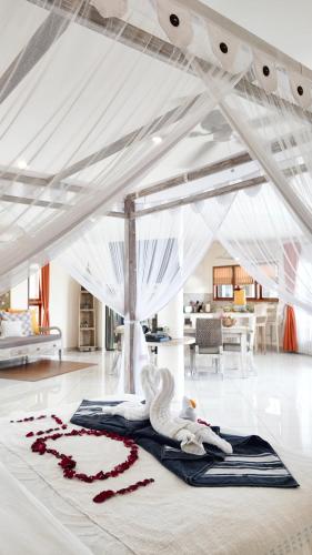 a swan laying on the floor of a room at Luz_ita Sunshine Villa in Uluwatu