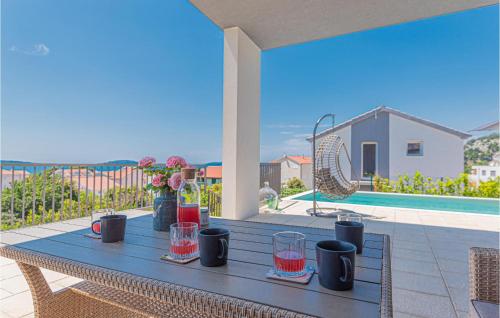 a table with glasses on it on a patio at Beautiful Home In Zaboric in Zaboric