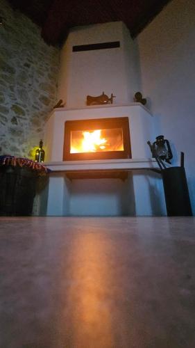 a fire in a fireplace in a room at Rafeio Roustic Maisonette in Episkopi (Heraklion)