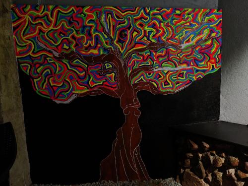 a painting of a tree with multicolored at Halli Hithalu Homestay in Chikmagalūr