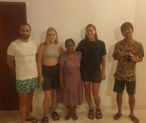 a group of people posing for a picture at Nature guesthous in Midigama