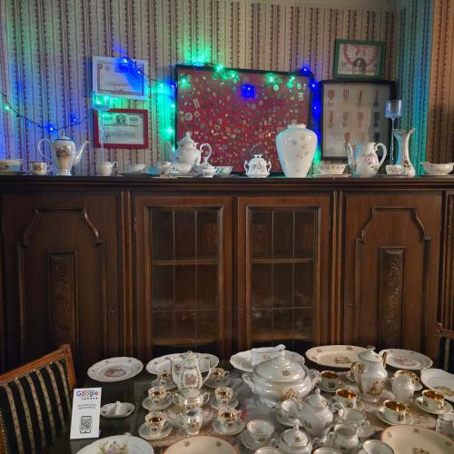 a table with plates and cups and bowls on it at Apartament Wilhelma II in Ząbkowice Śląskie