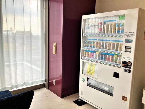 a refrigerator filled with drinks in a room at J Hotel Rinku in Tokoname