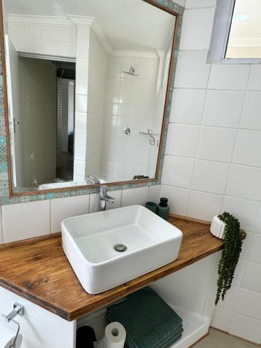 a bathroom with a white sink and a mirror at Secrets 3 in Jeffreys Bay