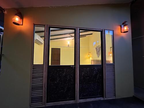 a building with glass doors and lights on it at Talpona Beach Studios in Canacona