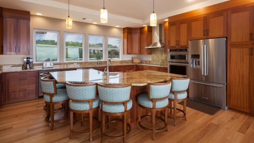 a kitchen with a large island with bar stools at HOME OF THE MILKY WAY Breathtaking Home Overlooking Ocean with Observatory in Kawaihae