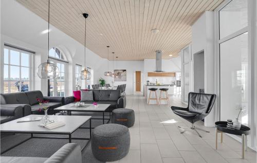 a living room with couches and tables and a kitchen at 7 Bedroom Gorgeous Home In Ulfborg in Øby
