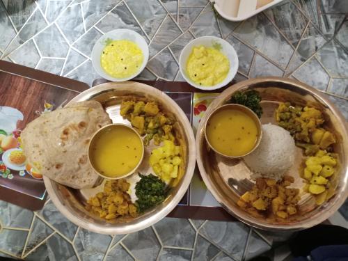 a table with two bowls of food with dipping sauce at Sunshine homestay in Tānsing