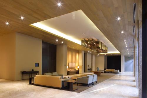 a lobby with couches and a table and a piano at Casa Maat at JW Marriott Los Cabos Beach Resort & Spa in San José del Cabo