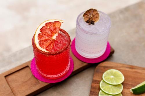 a drink with a grapefruit cut in half on a cutting board at Casa Maat at JW Marriott Los Cabos Beach Resort & Spa in San José del Cabo