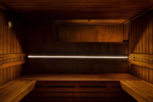 an empty wooden sauna with a light in it at Casa Maat at JW Marriott Los Cabos Beach Resort & Spa in San José del Cabo