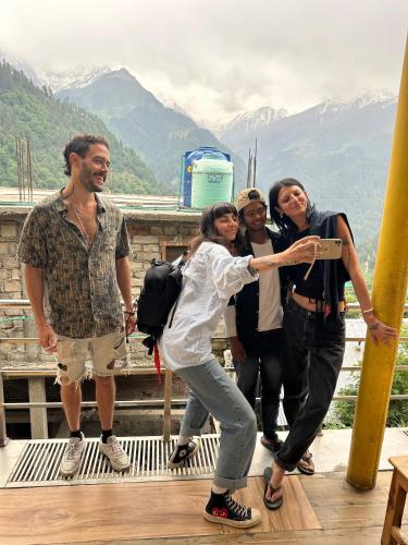 a group of people posing for a picture on a mountain at Hotel 19 Tosh in Tosh