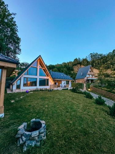 a house with a large yard in front of it at The Cliff Village in Comarnic