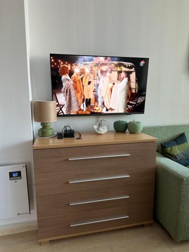 a tv on top of a dresser in a living room at Mountain View, Grand Monastery Pamporovo, top location in Pamporovo