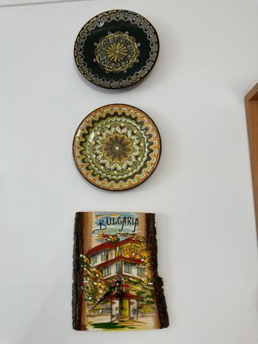 two plates and a picture on a wall at Mountain View, Grand Monastery Pamporovo, top location in Pamporovo