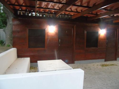 a room with two benches in front of a building at Hostal Villas Mexico in San Juan del Sur
