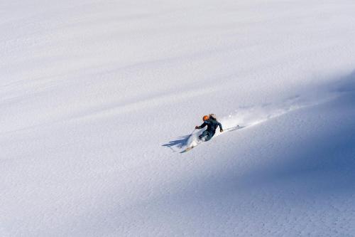 a person skiing down a snow covered slope at SCHLOSS Zermatt - CBD & Adaptogenic Spa and Sport Hotel in Zermatt