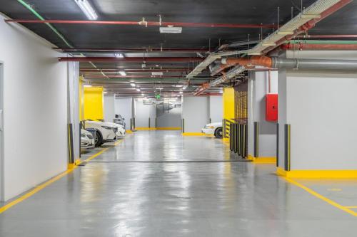 an empty parking garage with cars parked in it at Elaf Qinwan Hotel in Makkah
